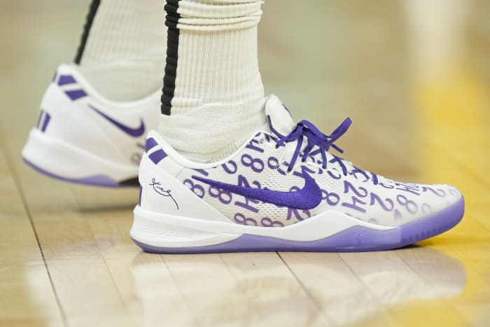 Golden State Warriors forward Jonathan Kuminga's white and purple Nike Kobe sneakers.